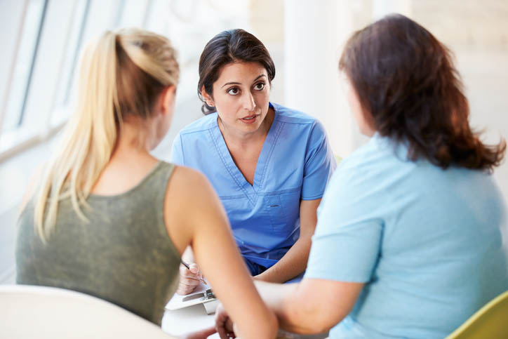 Nurse talking with two people