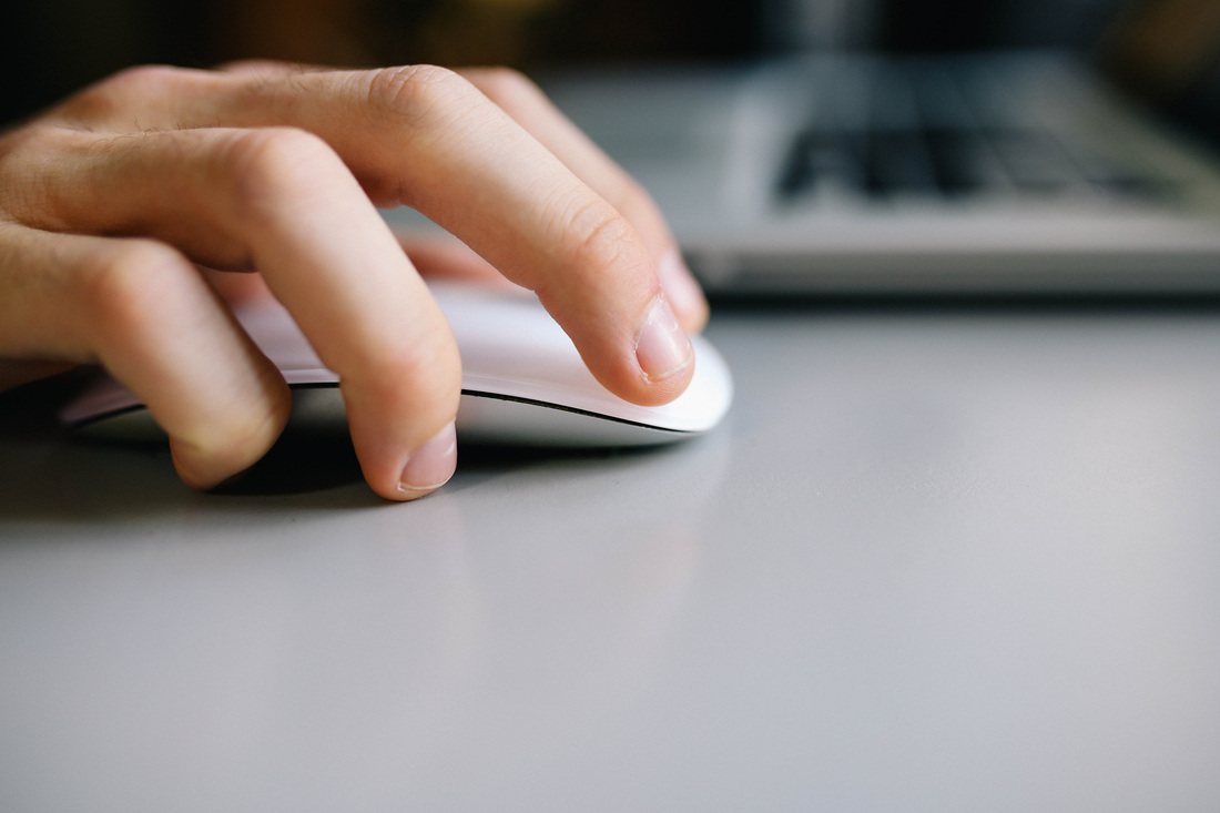 Picture of a hand using a computer mouse