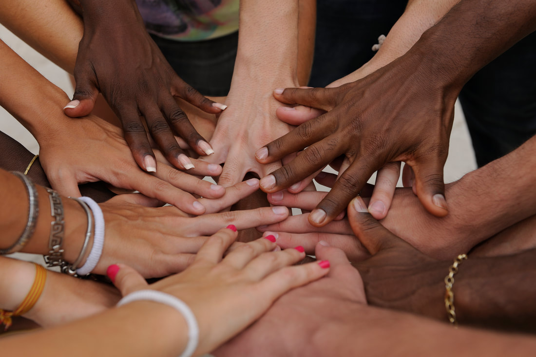 Group of diverse hands stacked to show solidarity