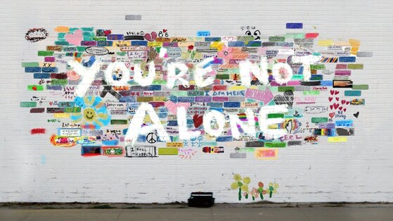 Painted wall with the words, You're Not Alone